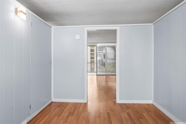 419A Atkinson Dr Unit 1203, Honolulu, HI 96814 - unfurnished room with wood finished floors, a textured ceiling, baseboards, and a smoke detector