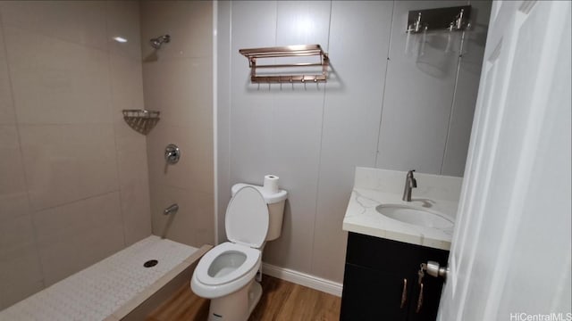 3904 Maunahilu Pl, Honolulu, HI 96816 - bathroom with toilet, tiled shower, wood finished floors, vanity, and baseboards