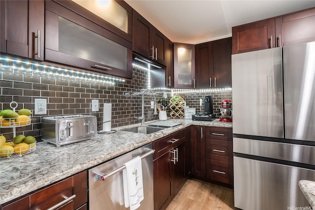 430 Keoniana St Unit 202, Honolulu, HI 96815 - kitchen with stainless steel appliances, backsplash, glass insert cabinets, and light stone counters