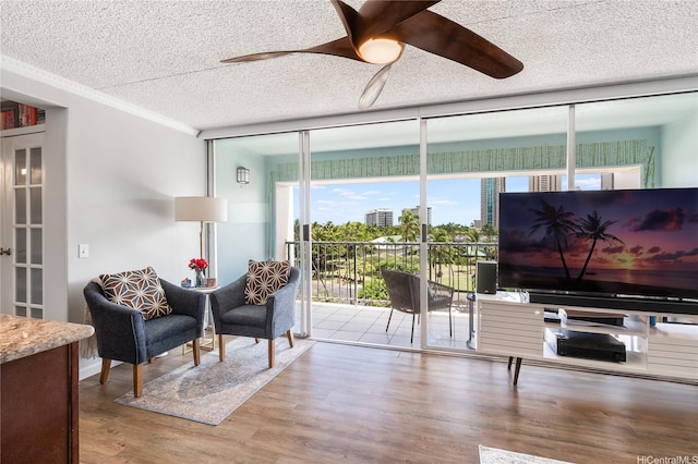 430 Keoniana St Unit 202, Honolulu, HI 96815 - living area with a wall of windows, a textured ceiling, a ceiling fan, and wood finished floors