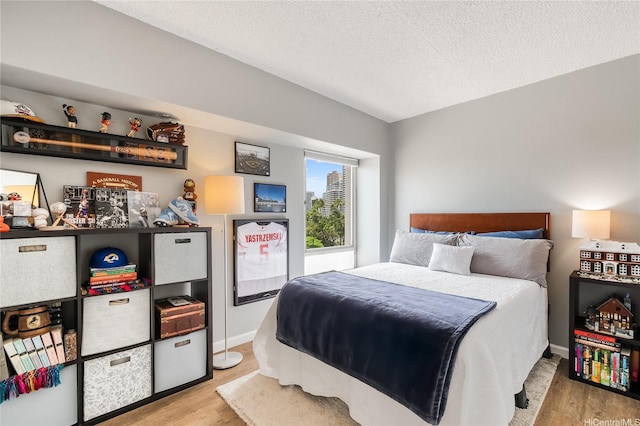 430 Keoniana St Unit 202, Honolulu, HI 96815 - bedroom with wood finished floors and a textured ceiling