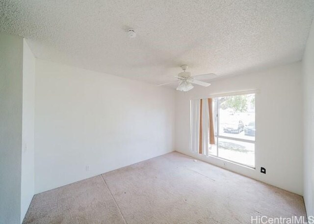 91-1089 Puamaeole St Unit 15C, Ewa Beach, HI 96706 - carpeted empty room with a textured ceiling and ceiling fan