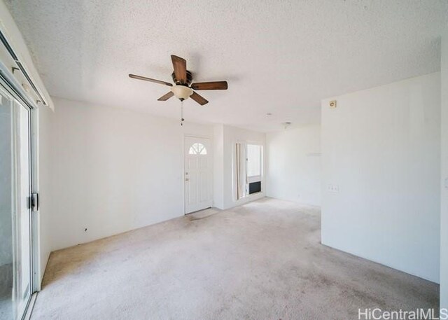 91-1089 Puamaeole St Unit 15C, Ewa Beach, HI 96706 - spare room featuring ceiling fan, carpet floors, and a textured ceiling