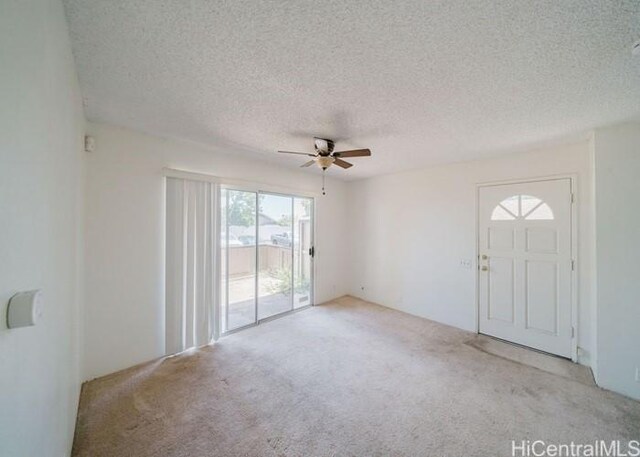 91-1089 Puamaeole St Unit 15C, Ewa Beach, HI 96706 - spare room with carpet, a ceiling fan, and a textured ceiling