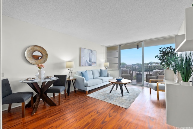 3161 Ala Ilima St Unit 1006, Honolulu, HI 96818 - living area featuring a textured ceiling, wood finished floors, and a wall of windows