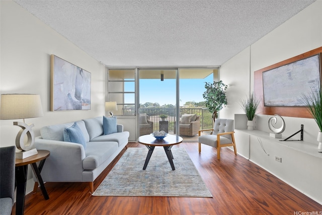 3161 Ala Ilima St Unit 1006, Honolulu, HI 96818 - living area featuring a wall of windows, a textured ceiling, and wood finished floors