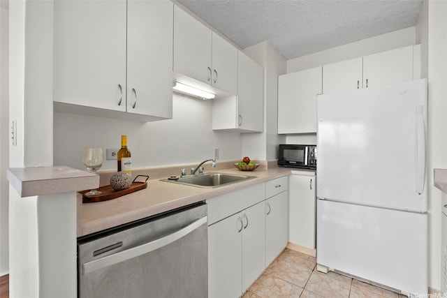 3161 Ala Ilima St Unit 1006, Honolulu, HI 96818 - kitchen with freestanding refrigerator, dishwasher, black microwave, a sink, and light countertops