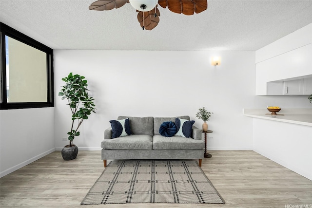 1571 Piikoi St Unit 503, Honolulu, HI 96822 - living room with a ceiling fan, light wood-style flooring, a textured ceiling, and baseboards