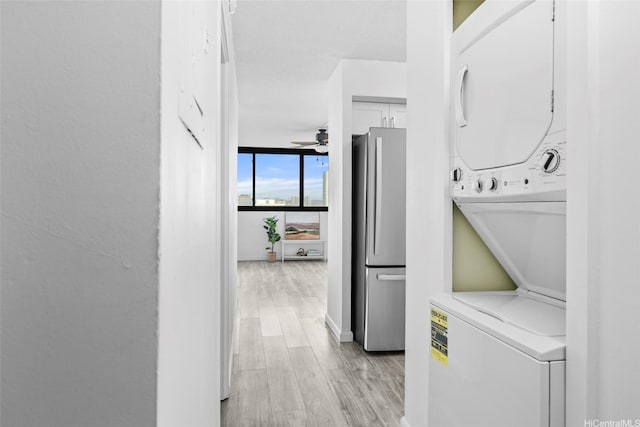 1571 Piikoi St Unit 503, Honolulu, HI 96822 - clothes washing area with stacked washer / drying machine, light wood-style floors, a ceiling fan, and baseboards