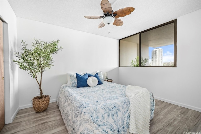 1571 Piikoi St Unit 503, Honolulu, HI 96822 - bedroom with wood finished floors, baseboards, and ceiling fan