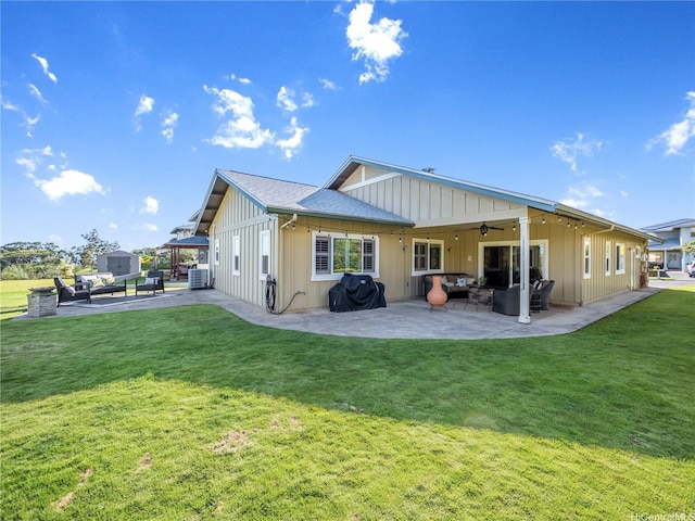 95-1073 Loea St, Honolulu, HI 96789 - back of house featuring a patio, a ceiling fan, a lawn, board and batten siding, and an outdoor living space