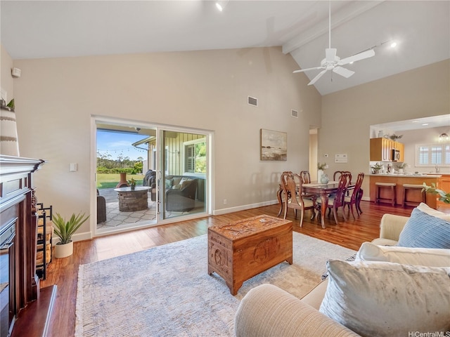 95-1073 Loea St, Honolulu, HI 96789 - living room with a fireplace, beam ceiling, high vaulted ceiling, wood finished floors, and ceiling fan