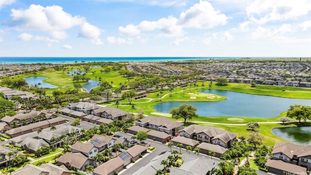 aerial perspective of suburban area featuring a nearby body of water and a golf club