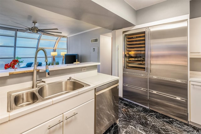 415 S St Unit 4202, Honolulu, HI 96813 - kitchen with dark marble finish flooring, a sink, ceiling fan, appliances with stainless steel finishes, and white cabinets