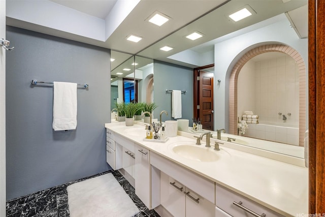 415 S St Unit 4202, Honolulu, HI 96813 - full bathroom with marble finish floors, inlaid floor details, double vanity, a relaxing tiled tub, and recessed lighting