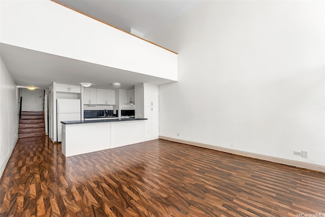 666 Prospect St Unit I506, Honolulu, HI 96813 - unfurnished living room with baseboards, a sink, stairs, and dark wood finished floors