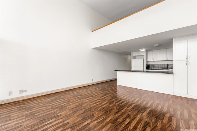 666 Prospect St Unit I506, Honolulu, HI 96813 - unfurnished living room with baseboards, dark wood finished floors, and a sink