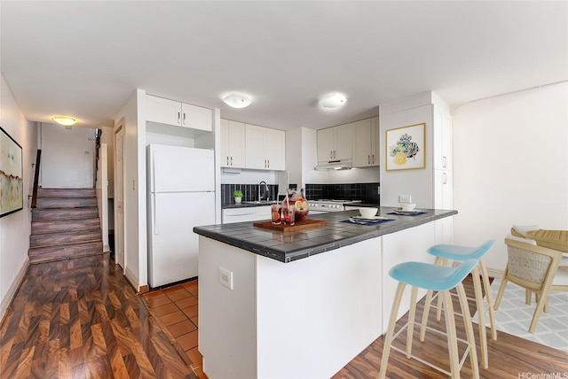 666 Prospect St Unit I506, Honolulu, HI 96813 - kitchen with white appliances, a sink, a peninsula, under cabinet range hood, and a breakfast bar