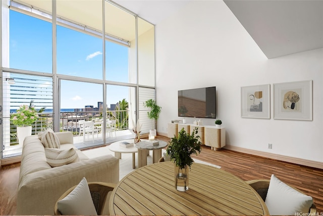 666 Prospect St Unit I506, Honolulu, HI 96813 - living area featuring a high ceiling, wood finished floors, healthy amount of natural light, baseboards, and a wall of windows