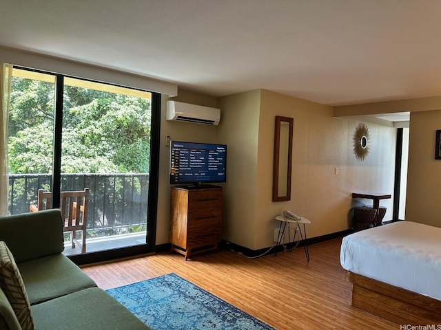 2425 Kuhio Ave Unit 410, Honolulu, HI 96815 - bedroom with a wall unit AC, wood finished floors, and baseboards