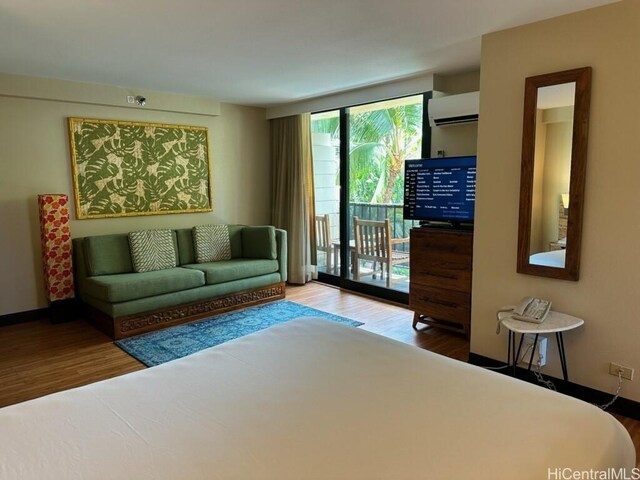 2425 Kuhio Ave Unit 410, Honolulu, HI 96815 - living area featuring wood finished floors and an AC wall unit