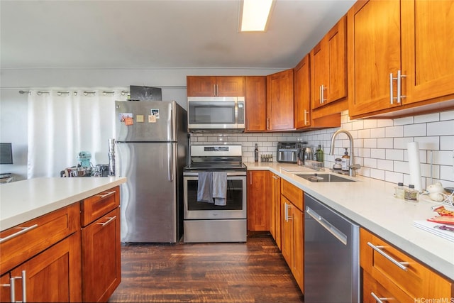 1492 Halekoa Dr, Honolulu, HI 96821 - kitchen with stainless steel appliances, a sink, dark wood finished floors, light countertops, and brown cabinets