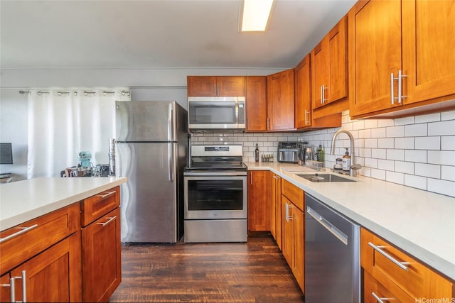 1492 Halekoa Dr, Honolulu, HI 96821 - kitchen featuring stainless steel appliances, a sink, dark wood finished floors, light countertops, and brown cabinets