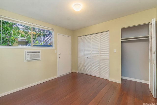 1492 Halekoa Dr, Honolulu, HI 96821 - unfurnished bedroom with dark wood-style flooring, baseboards, multiple closets, and an AC wall unit