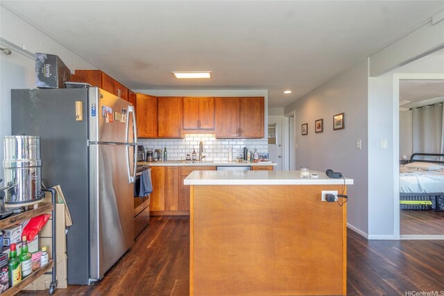 1492 Halekoa Dr, Honolulu, HI 96821 - kitchen with appliances with stainless steel finishes, light countertops, dark wood finished floors, a kitchen island, and decorative backsplash