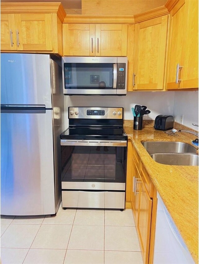 57-120 Lalo Kuilima Way Unit 2/17, Kahuku, HI 96731 - kitchen with appliances with stainless steel finishes, a sink, light tile patterned floors, and light stone countertops