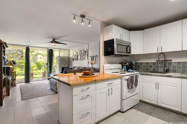 95-061 Waikalani Dr Unit D104, Mililani, HI 96789 - kitchen featuring stainless steel microwave, white electric range, a sink, and light tile patterned floors