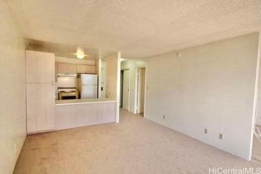 1255 Nuuanu Ave Unit 2113, Honolulu, HI 96817 - unfurnished living room featuring a textured ceiling and light colored carpet