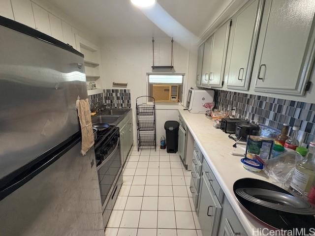 1704 Kamamalu Ave, Honolulu, HI 96813 - kitchen with appliances with stainless steel finishes, light tile patterned floors, light countertops, gray cabinets, and backsplash
