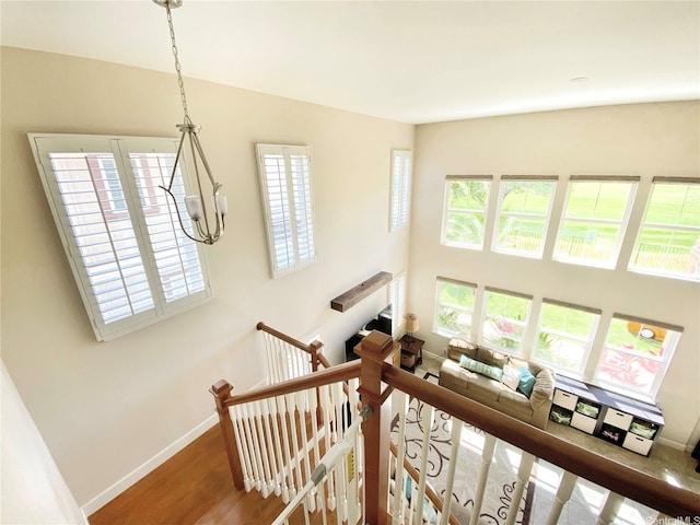 91-1103 Waikai St, Ewa Beach, HI 96706 - staircase featuring wood finished floors, baseboards, a chandelier, and a high ceiling