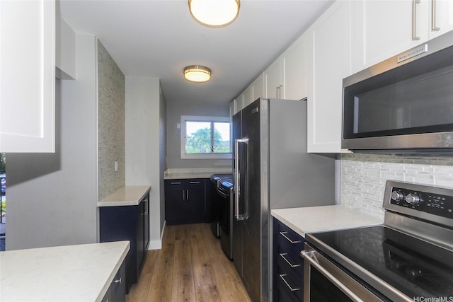 444 Lunalilo Home Rd Unit 226, Honolulu, HI 96825 - kitchen featuring stainless steel appliances, white cabinets, wood finished floors, and backsplash