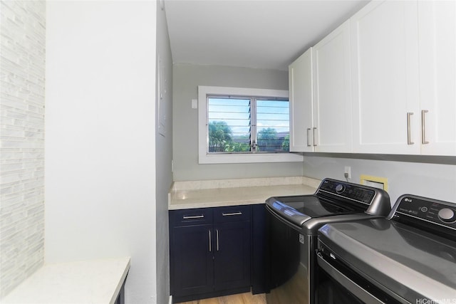 444 Lunalilo Home Rd Unit 226, Honolulu, HI 96825 - washroom with cabinet space, washing machine and clothes dryer, and light wood finished floors