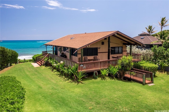 56-189 Kamehameha Hwy, Kahuku, HI 96731 - back of property featuring a lawn, a deck with water view, and a shingled roof