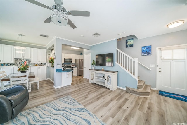 91-2222 Kanela St Unit T88, Ewa Beach, HI 96706 - living room featuring stairs, a ceiling fan, light wood-style flooring, ornamental molding, and baseboards