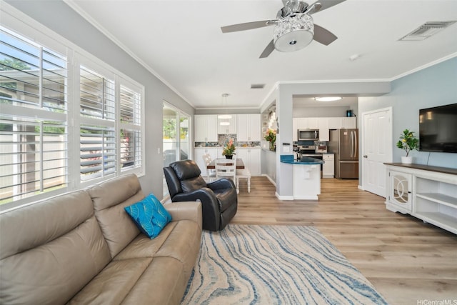 91-2222 Kanela St Unit T88, Ewa Beach, HI 96706 - living area featuring light wood finished floors, ornamental molding, a ceiling fan, and baseboards