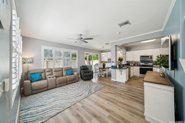 91-2222 Kanela St Unit T88, Ewa Beach, HI 96706 - living room featuring ornamental molding, light wood-type flooring, and ceiling fan
