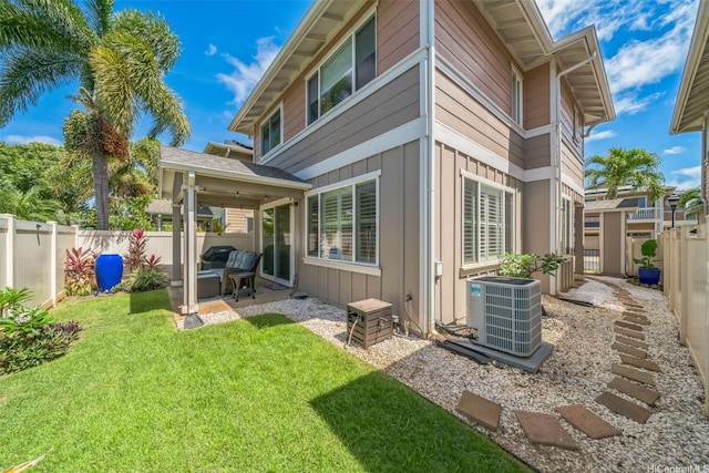 91-2222 Kanela St Unit T88, Ewa Beach, HI 96706 - rear view of house with central AC unit, board and batten siding, and a patio area