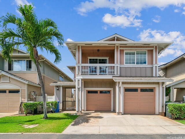 91-2222 Kanela St Unit T88, Ewa Beach, HI 96706 - view of front of home featuring a balcony, driveway, a garage, fence, and board and batten siding