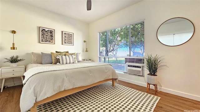91-540 Puamaeole St Unit 49D, Ewa Beach, HI 96706 - bedroom featuring wood finished floors, baseboards, ceiling fan, and cooling unit