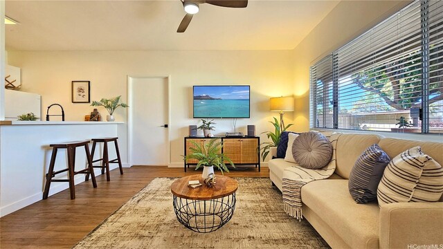 91-540 Puamaeole St Unit 49D, Ewa Beach, HI 96706 - living room featuring wood finished floors, a ceiling fan, and baseboards