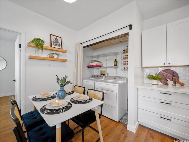 91-540 Puamaeole St Unit 49D, Ewa Beach, HI 96706 - dining area with light wood-style flooring and separate washer and dryer
