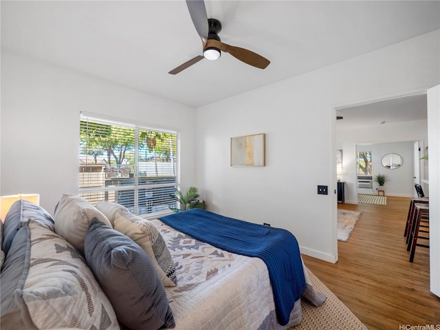 91-540 Puamaeole St Unit 49D, Ewa Beach, HI 96706 - bedroom with multiple windows, wood finished floors, and ceiling fan