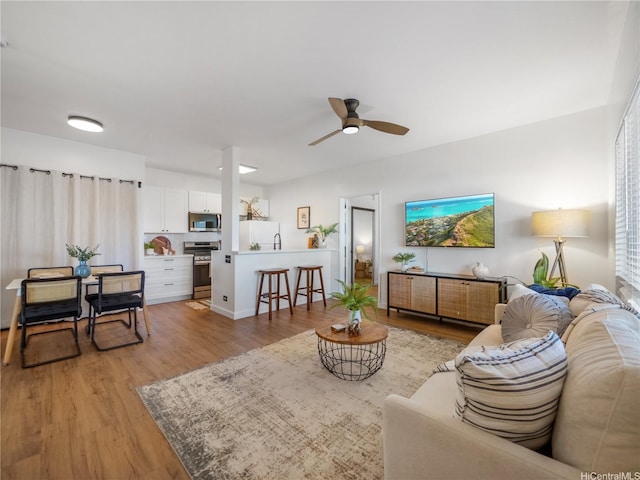 91-540 Puamaeole St Unit 49D, Ewa Beach, HI 96706 - living area featuring light wood finished floors and ceiling fan