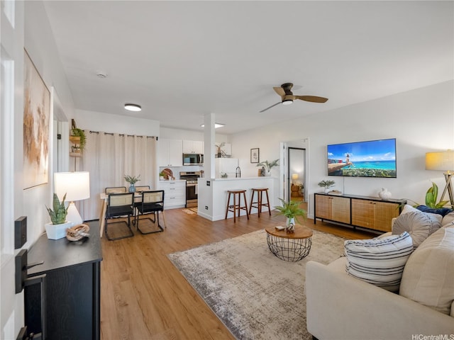 91-540 Puamaeole St Unit 49D, Ewa Beach, HI 96706 - living room with a ceiling fan and light wood-style floors