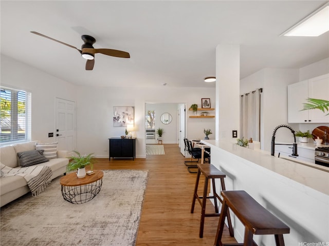91-540 Puamaeole St Unit 49D, Ewa Beach, HI 96706 - living area with ceiling fan and light wood finished floors
