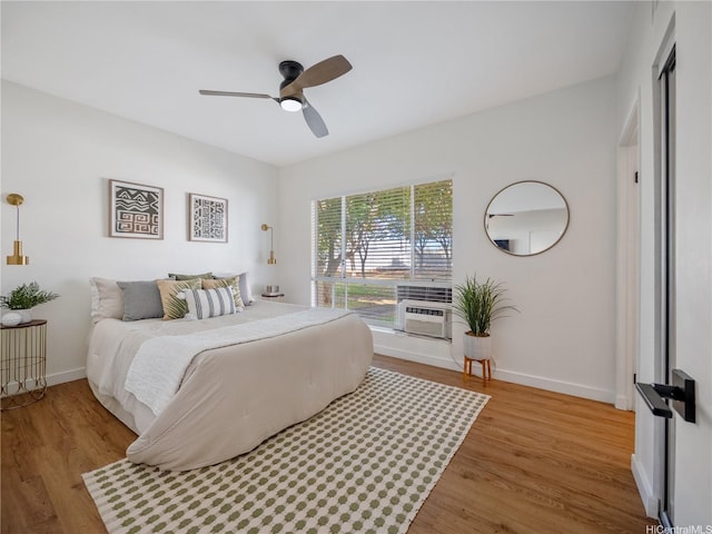 91-540 Puamaeole St Unit 49D, Ewa Beach, HI 96706 - bedroom with wood finished floors, a ceiling fan, and cooling unit